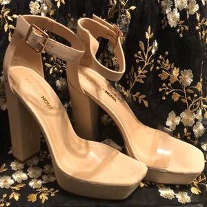 Heeled beige sandals with PVC strap.